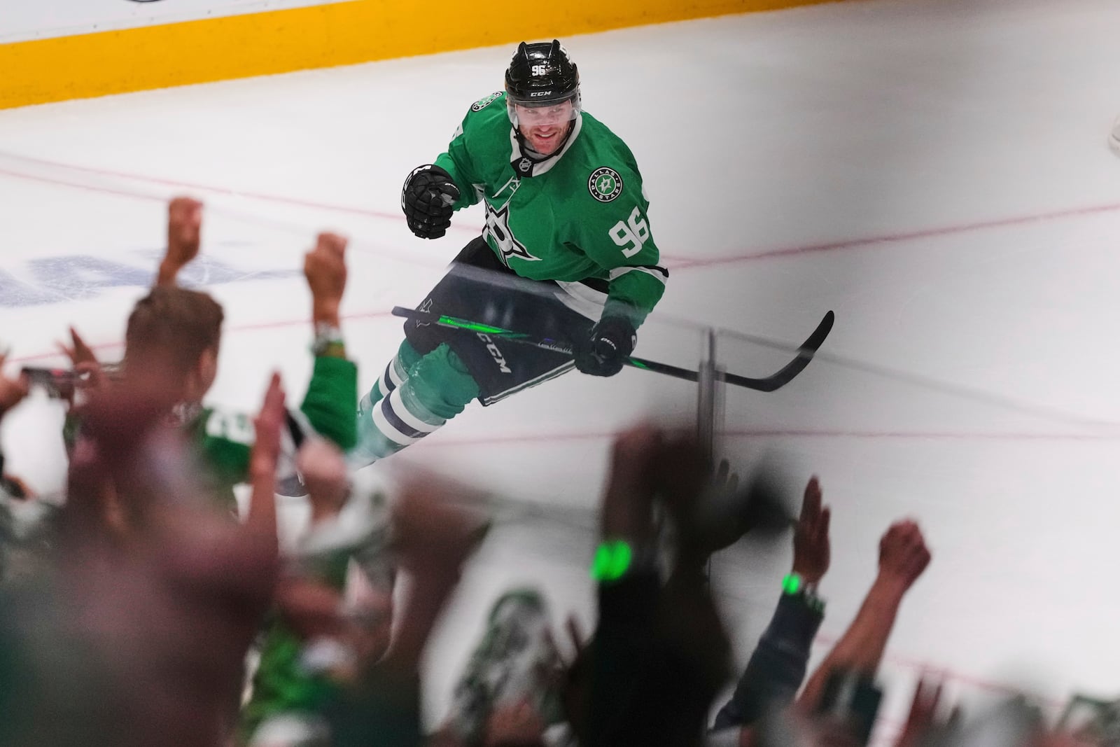 Fans and Dallas Stars' Mikko Rantanen, celebrate after Rantanen scored an emtpy-net goal against the Colorado Avalanche in the third period in Game 7 of a first-round NHL hockey playoff series Saturday, May 3, 2025, in Dallas. (AP Photo/Julio Cortez)