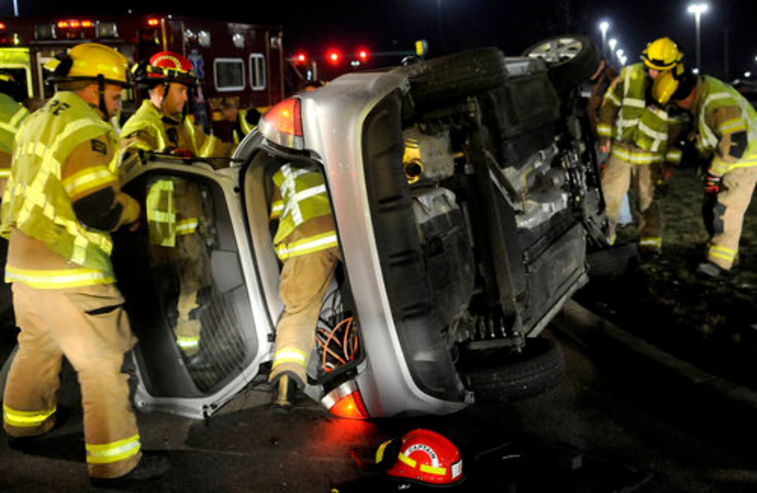 Car hits fire hydrant, turns on side