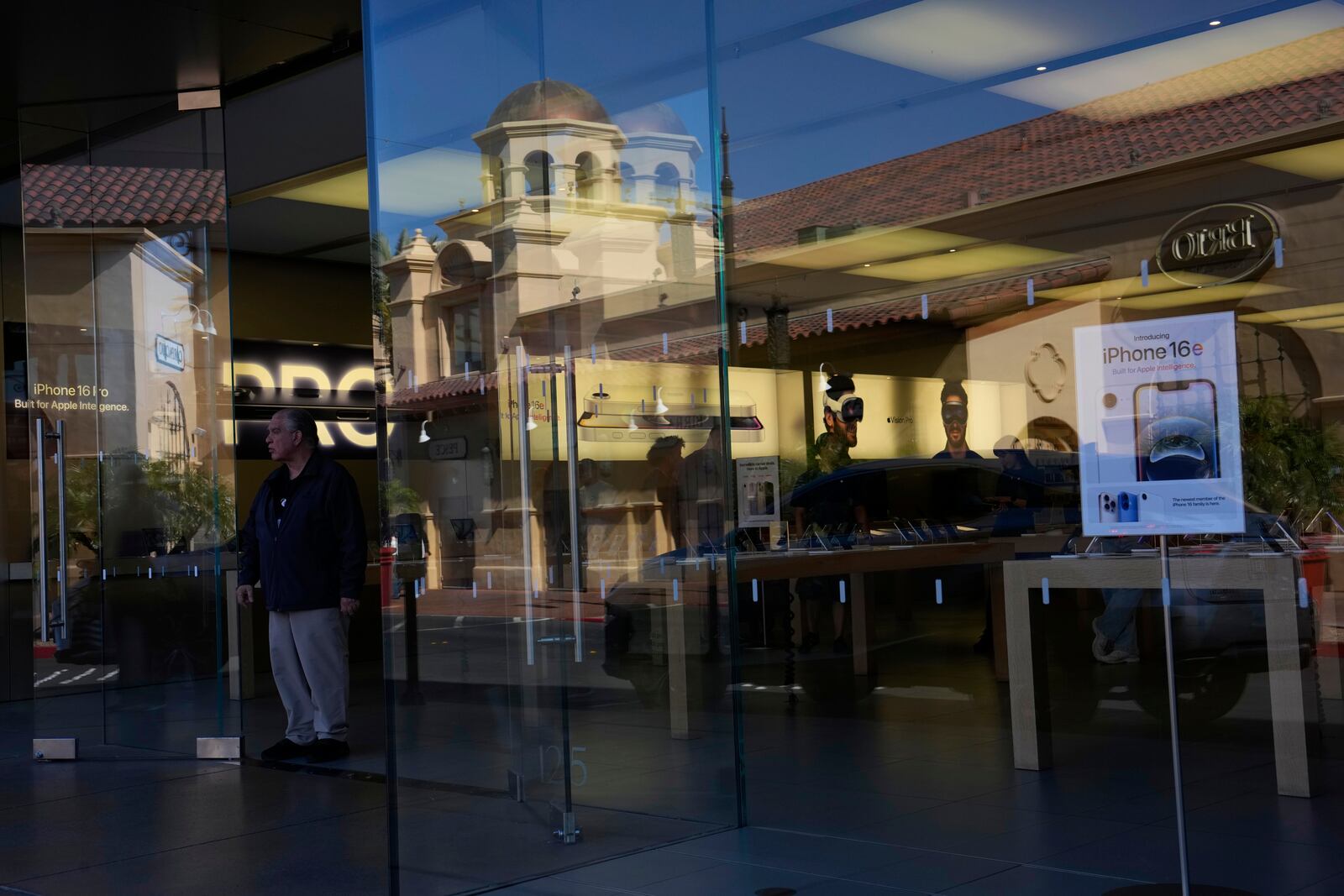 People shop in an Apple store Tuesday, April 8, 2025, in Las Vegas. (AP Photo/John Locher)