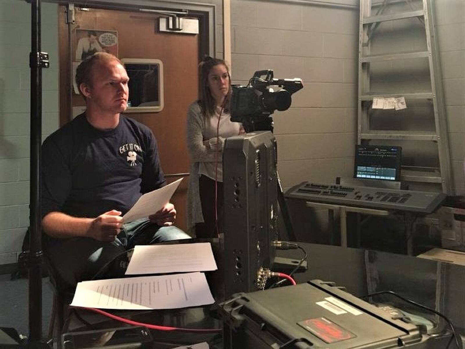 Johnny Antonini and another student work on “Epicenter: Dayton s Opioid Crisis,” a documentary film about addiction recovery created by University of Dayton students this year.