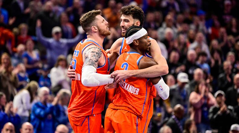 Oklahoma City Thunder center/forward Chet Holmgren (7), center, celebrates with Oklahoma City Thunder center/forward Isaiah Hartenstein (55) and Oklahoma City Thunder guard Shai Gilgeous-Alexander (2) during the second half of an Emirates NBA Cup basketball game, Wednesday, Nov. 26, 2025, in Oklahoma City. (AP Photo/Gerald Leong)