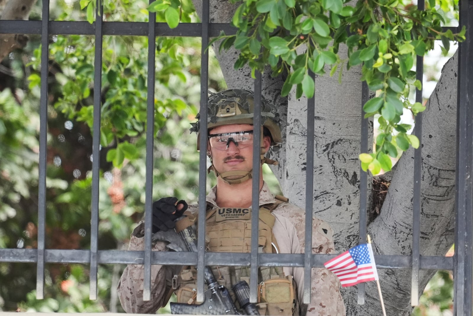 A U.S. Marine stages outside a business park on Monday, June 23, 2025, in Paramount, Calif. (AP Photo/Damian Dovarganes)