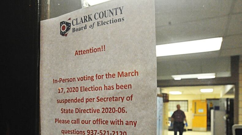A sign on the door of the election poll at Enon Elementary tells voters the election has been postponed Tuesday morning. MARSHALL GORBY/STAFF