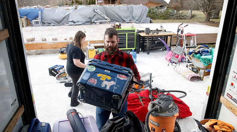 Jon Stewart and his family load the last of their belongings in the back of a U-Haul truck parked where his garage once stood Monday, March 4, 2024. Stewart's house on Mitchell Road was destroyed by the Feb. 28 tornado that hit the area. BILL LACKEY/STAFF