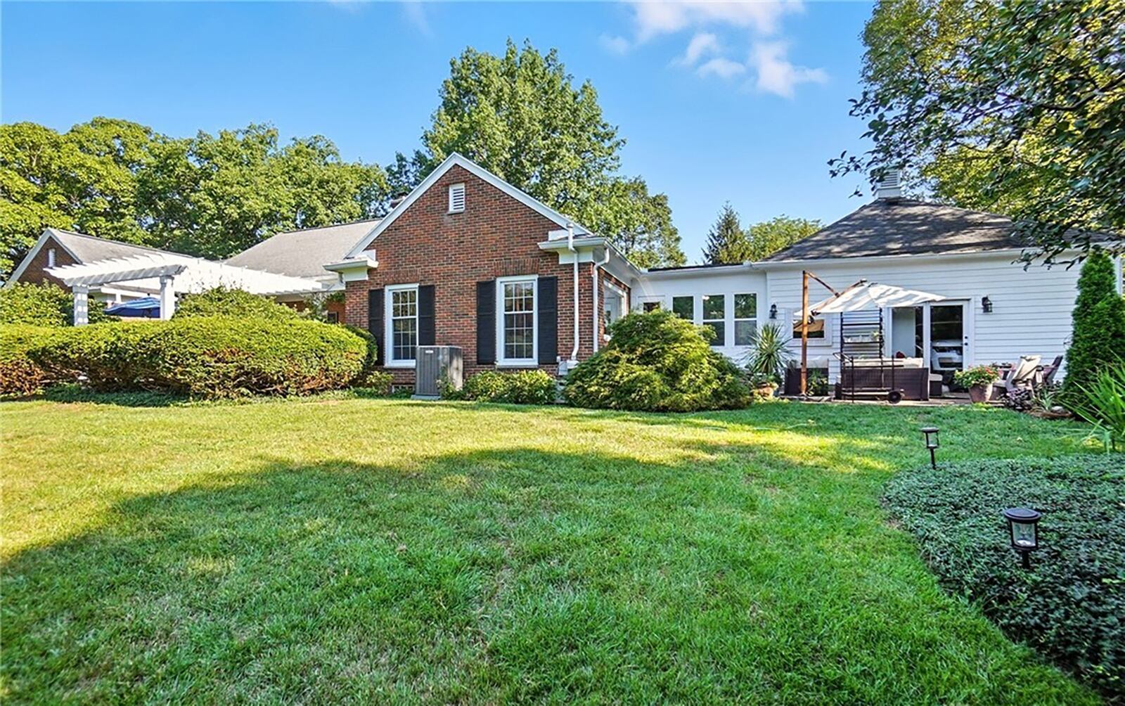 the fully fenced back yard features two paver patios, one with a wood pergola and both with new pavers. CONTRIBUTED