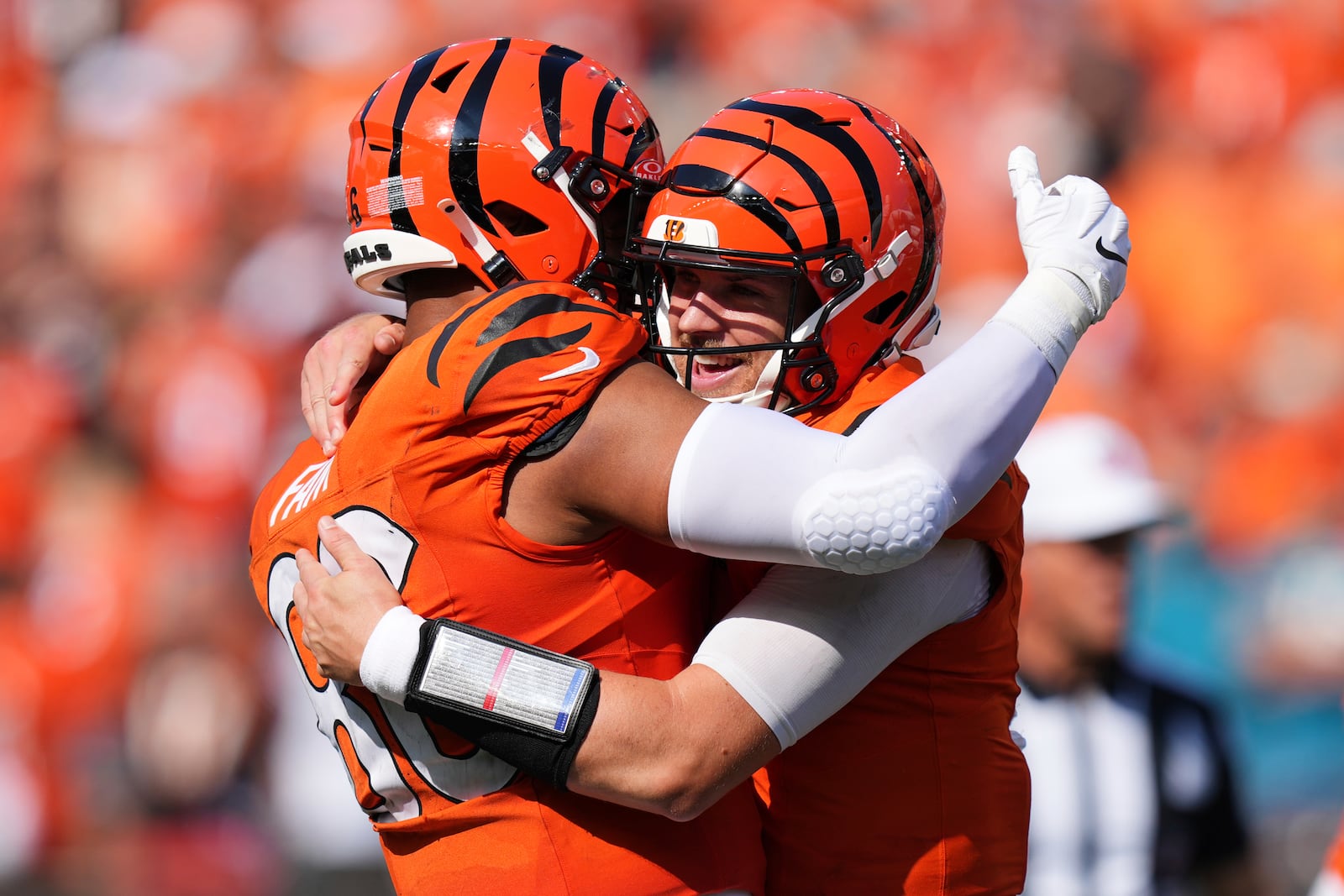 Cincinnati Bengals quarterback Jake Browning, right, is hugged by tight end Noah Fant after Browning's rushing touchdown during the second half of an NFL football game against the Jacksonville Jaguars, Sunday, Sept. 14, 2025, in Cincinnati. (AP Photo/Jeff Dean)