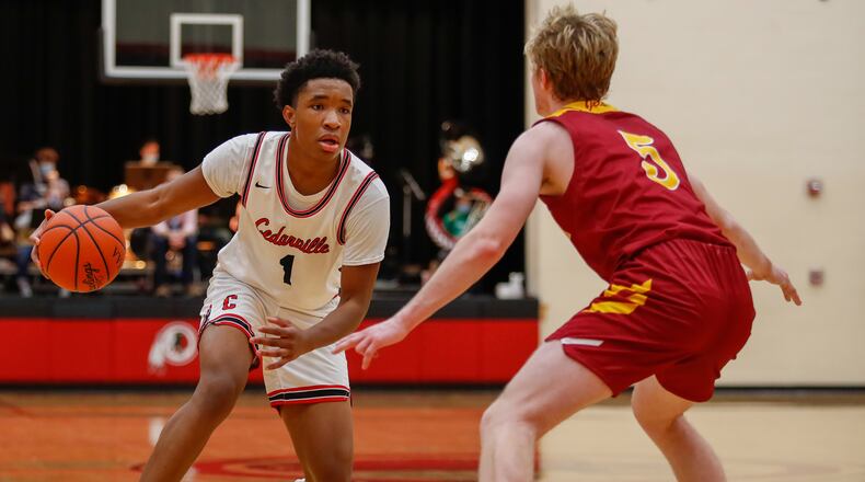Cedarville High School senior Isaiah Ramey is guarded by Northeastern's Cole Allen during their game on Tuesday night in Cedarville. Michael Cooper/CONTRIBUTED