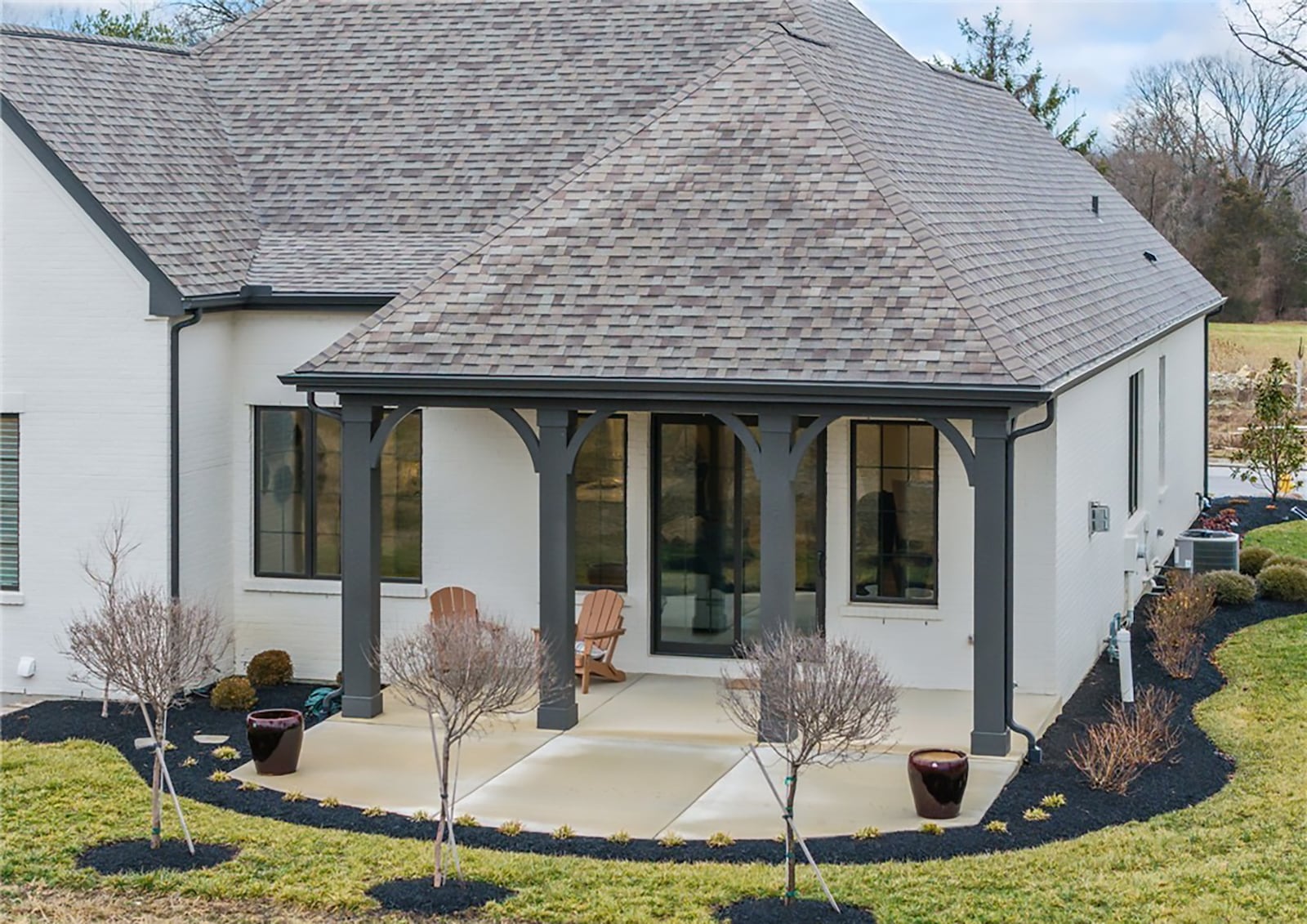 The back features a covered concrete patio and professional landscaping. CONTRIBUTED