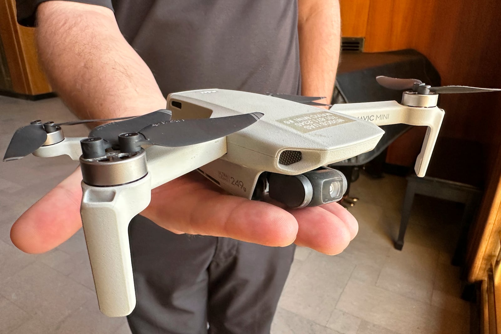 FILE - Seth Simonson, assistant professor/UAS curriculum lead for the North Dakota State College of Science, holds a Chinese-manufactured drone the college mainly uses for pilot training and photo and video collecting by students, at the state Capitol in Bismarck, N.D., on Jan. 15, 2025, (AP Photo/Jack Dura, File)