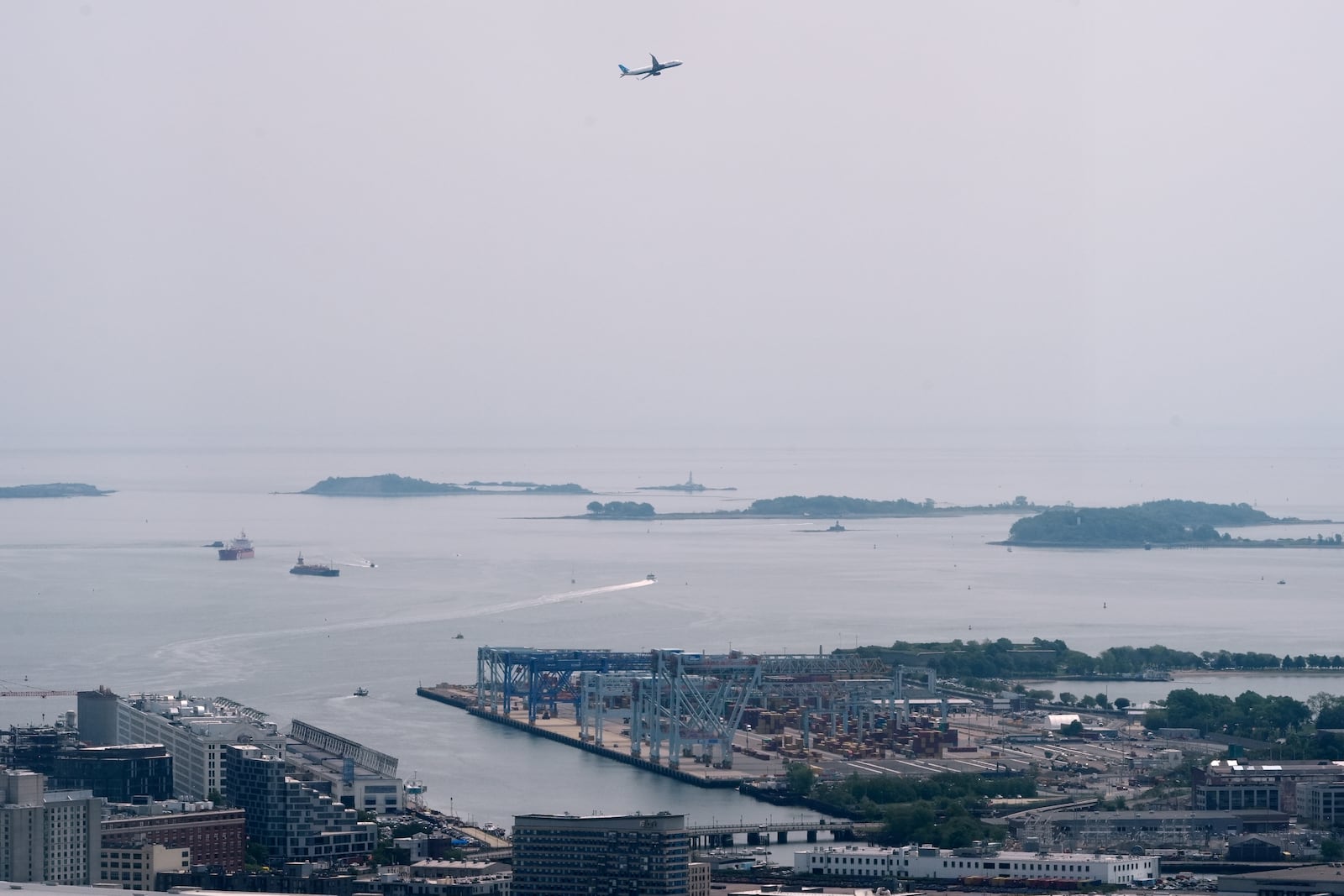 Hazy skies diminish the view of the Boston Harbor Islands, Wednesday, June 4, 2025, in Boston, Mass. (AP Photo/Robert F. Bukaty)