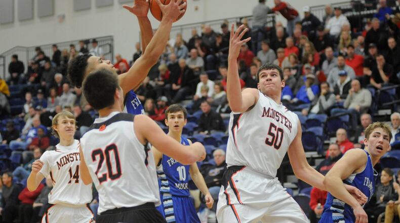 Franklin Monroe’s Ethan Conley gets a rebound over Minster’s Jack Heitbrink (20) and Jarod Schulze. Minster defeated Franklin Monroe 74-58 in the 16th annual Premier Health Flyin’ to the Hoop at Trent Arena in Kettering on Sun., Jan. 15, 2018. MARC PENDLETON / STAFF