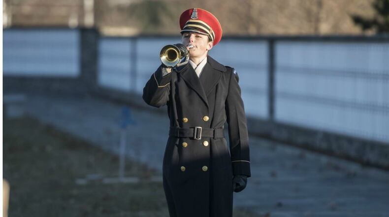Staff Sgt. Adrienne Doctor plays taps during the dedication ceremony for the Tomb of Remembrance in Section 72 of Arlington National Cemetery, Arlington, Virginia, Dec. 13, 2017. (U.S. Army photo by Elizabeth Fraser)