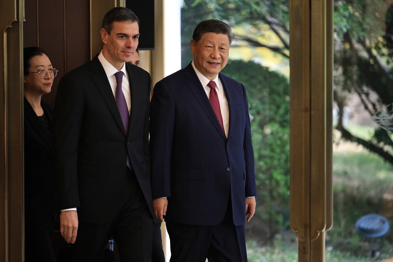 Chinese President Xi Jinping, right and Spanish Prime Minister Pedro Sanchez arrive for a bilateral meeting at Diaoyutai Guest House in Beijing, China, Friday, April 11, 2025. (Andres Martinez Casares/Pool Photo via AP)