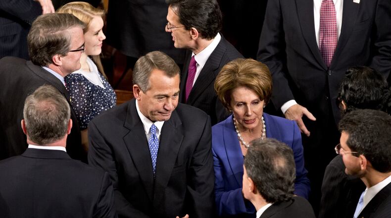 House Speaker John Boehner of Ohio enters the House of Representatives chamber on Capitol Hill in Washington, Thursday, Jan. 3, 2013, after surviving a roll call vote in the newly convened 113th Congress. He is escorted by House Majority Leader Eric Cantor of Va., and House Minority Leader Nancy Pelosi of Calif. (AP Photo/J. Scott Applewhite)