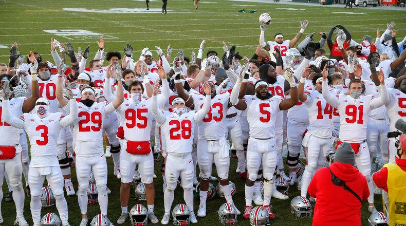Ohio State players celebrate following an NCAA college football game against Michigan State, Saturday, Dec. 5, 2020, in East Lansing, Mich. (AP Photo/Al Goldis)