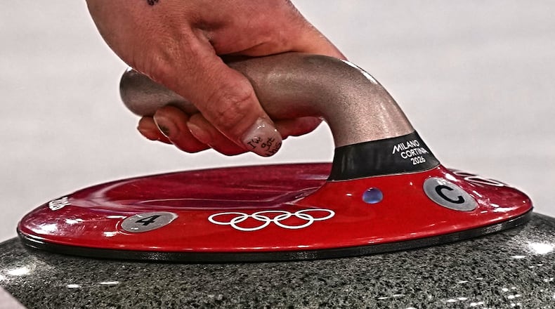 South Korea's Seol Ye-eun in action during the women's curling round robin session against Denmark, at the 2026 Winter Olympics, in Cortina d'Ampezzo, Italy, Saturday, Feb.14, 2026. (AP Photo/Fatima Shbair)