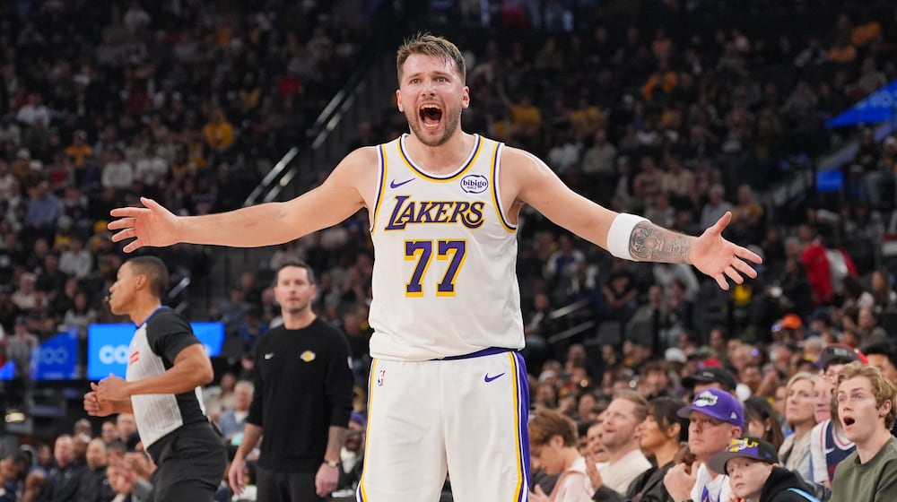 Los Angeles Lakers forward/guard Luka Doncic (77) reacts to a play during the first half of an NBA basketball game against the Los Angeles Clippers Saturday, Dec. 20, 2025, in Inglewood, Calif. (AP Photo/Jae C. Hong)