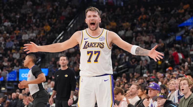Los Angeles Lakers forward/guard Luka Doncic (77) reacts to a play during the first half of an NBA basketball game against the Los Angeles Clippers Saturday, Dec. 20, 2025, in Inglewood, Calif. (AP Photo/Jae C. Hong)
