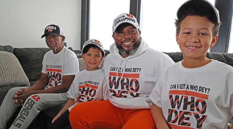 Brandon Peterson with his sons, Brandon, Jr., and Noah along with Brandon's father, Noah, ara all four Bengals fans. BILL LACKEY/STAFF