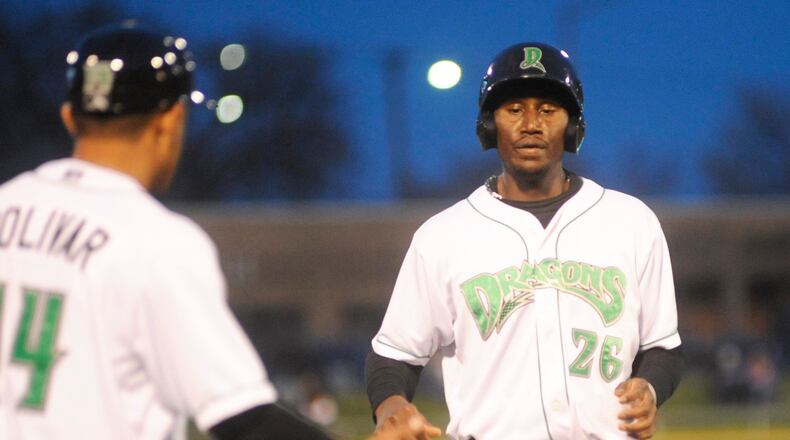 Dragons first baseman Montrell Marshall (right) greets manager Luis Bolivar. The Dragons defeated the visiting Lake County Captains 9-3 at Fifth Third Field in Dayton on Wed., April 11, 2018. MARC PENDLETON / STAFF
