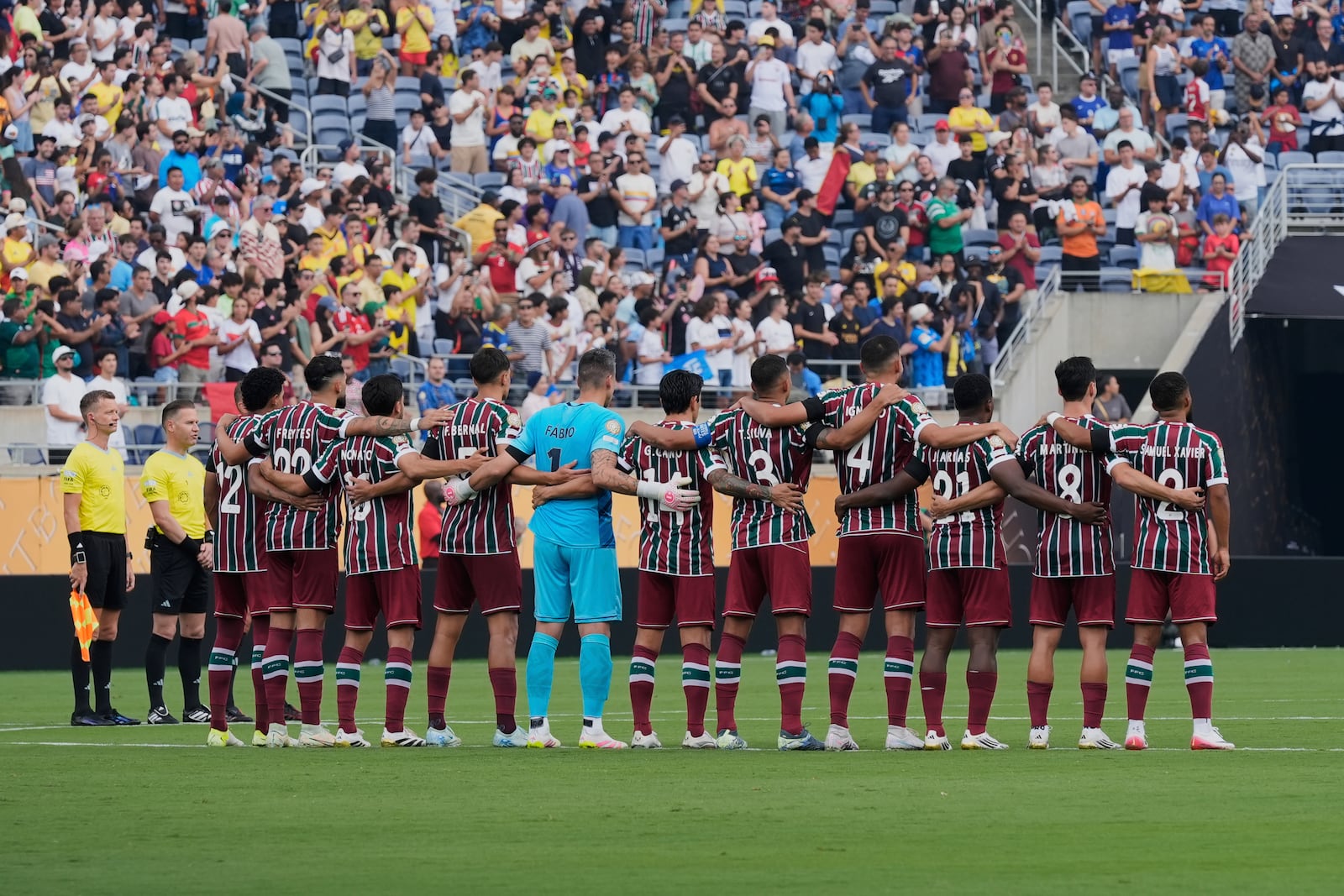 Players of the two teams observe a minute of silence in memory of Portugal international and Liverpool player Diogo Jota and his brother Andre Silva, before the Club World Cup quarterfinal soccer match between Fluminense and Al Hilal in Orlando, Fla., Friday, July 4, 2025. (AP Photo/John Raoux)