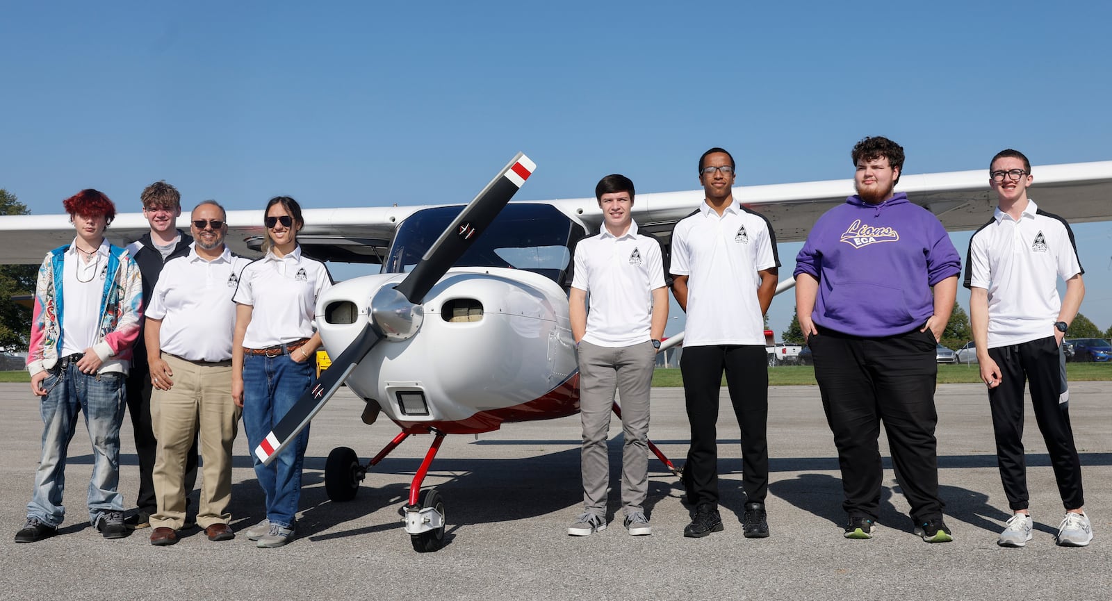 Students with Emmanuel Christian Academy dual enrollment aviation program pose for a photo next to a plane on Monday, September 29, 2025, at Springfield-Beckley Municipal Airport. JOSEPH COOKE/STAFF
