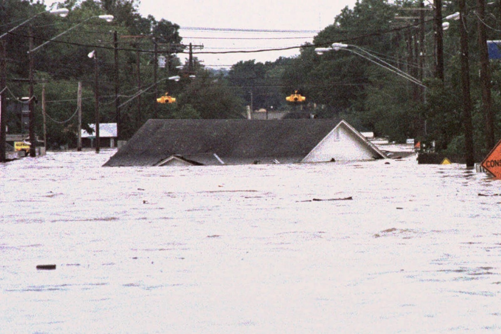 FILE - The home of Richard and Angie Navarro floats through the town of Cuero, Texas as floodwaters from the Guadalupe River rise on Monday, Oct. 19, 1998. (AP Photo/David J. Phillip, File)