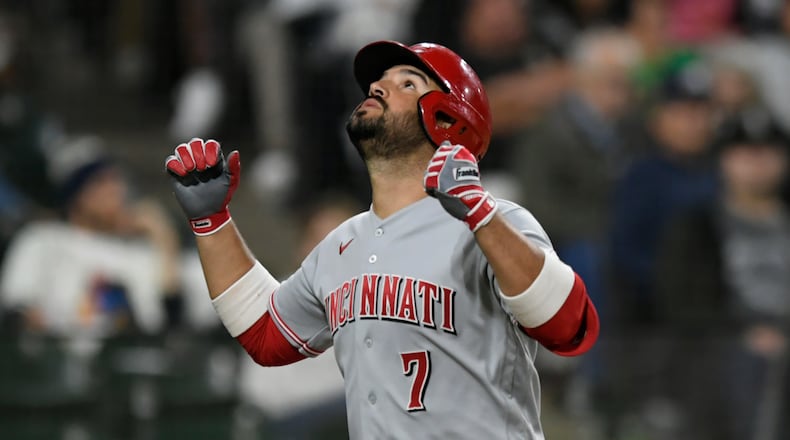Cincinnati Reds' Eugenio Suarez (7) celebrates at home plate after hitting a solo home run during the fifth inning of a baseball game against the Chicago White Sox Tuesday, Sept. 28, 2021, in Chicago. (AP Photo/Paul Beaty)