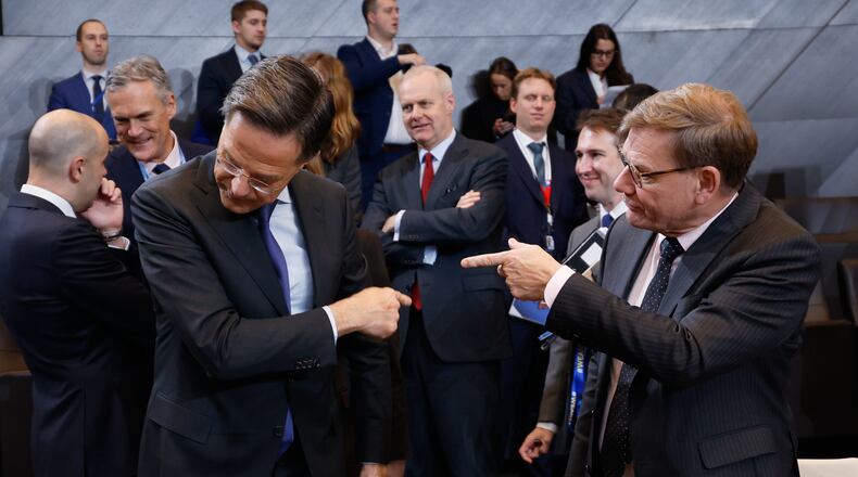 Germany's Foreign Minister Johann Wadephul, right, speaks with NATO Secretary General Mark Rutte during a meeting of the North Atlantic Council in Foreign Ministers Session at NATO headquarters in Brussels, Wednesday, Dec. 3, 2025. (AP Photo/Geert Vanden Wijngaert)