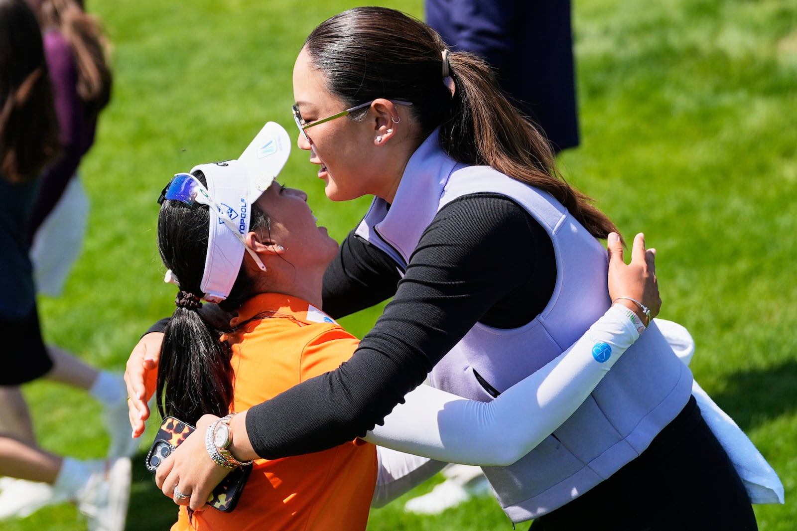 Michelle Wie West, right, hugs Jeeno Thitikul, of Thailand, after Thitikul won the Mizuho Americas Open LPGA golf tournament, Sunday, May 11, 2025, in Jersey City, N.J. (AP Photo/Seth Wenig)