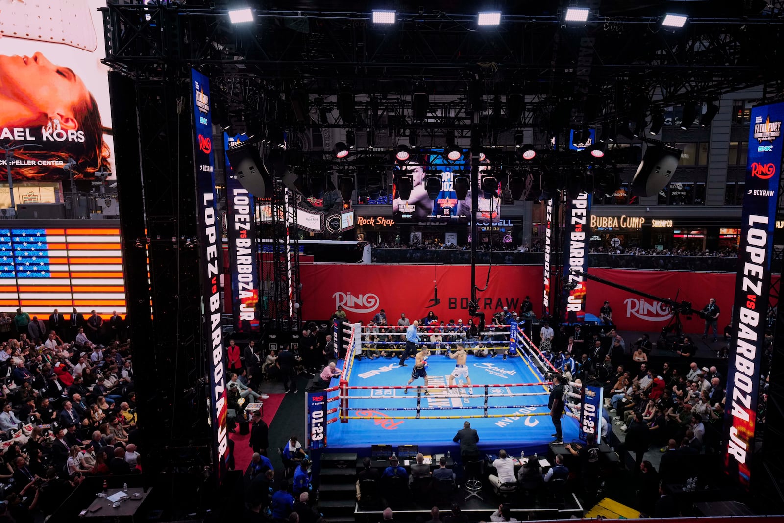 People gather in Times Square to watch a boxing match Friday, May 2, 2025, in New York. (AP Photo/Frank Franklin II)