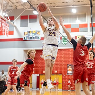 Emmanuel Christian senior Nate Hudson drives to the hoop during their 73-51 victory over Twin Valley South 73-51 in a Division VI district semifinal game on Monday, March 3, 2026 at Troy High School. MICHAEL COOPER / STAFF