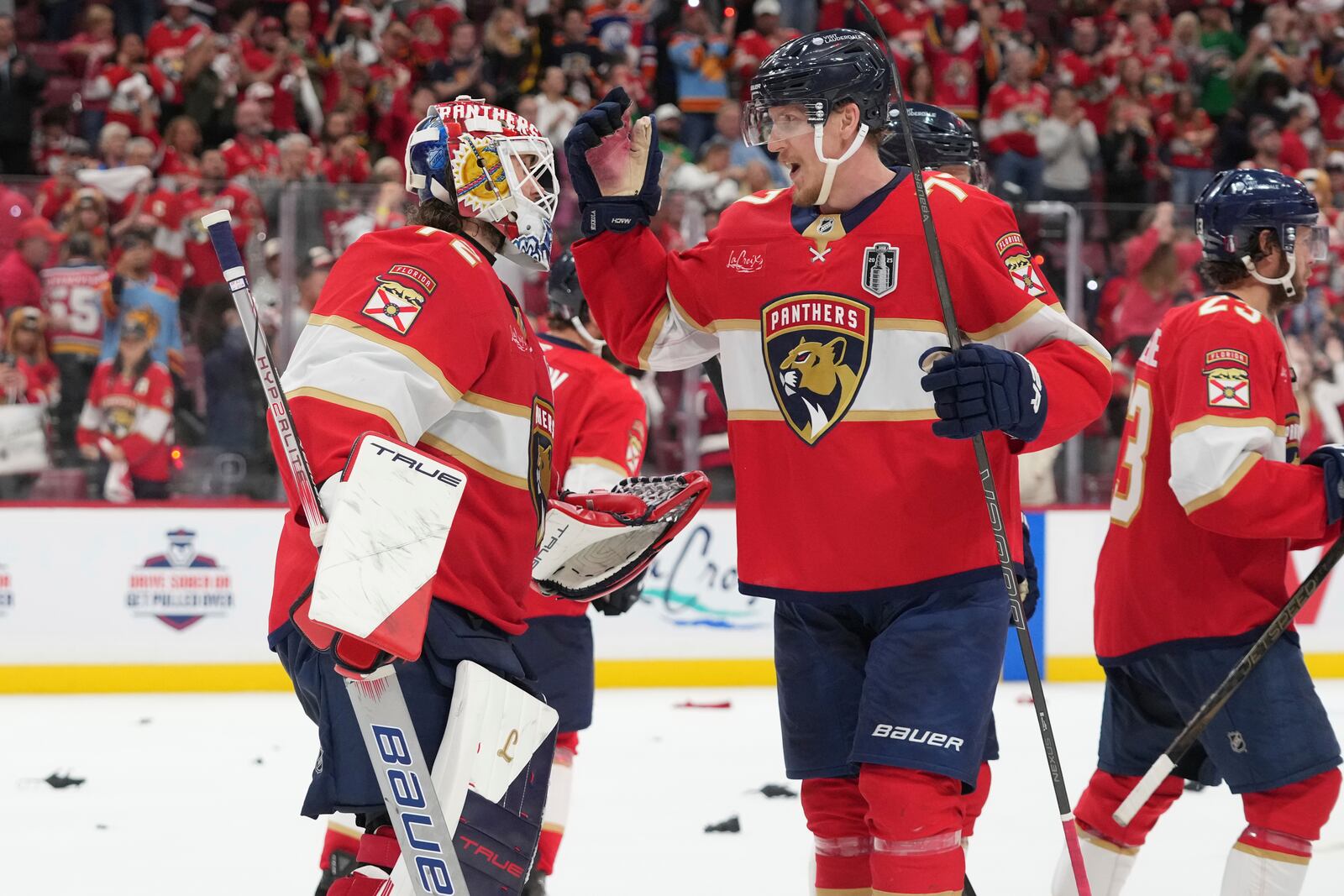 Florida Panthers defenseman Niko Mikkola (77) congratulates goaltender Sergei Bobrovsky (72) after defeating the Edmonton Oilers in Game 3 of the NHL Stanley Cup final Monday, June 9, 2025, in Sunrise, Fla. (AP Photo/Lynne Sladky)