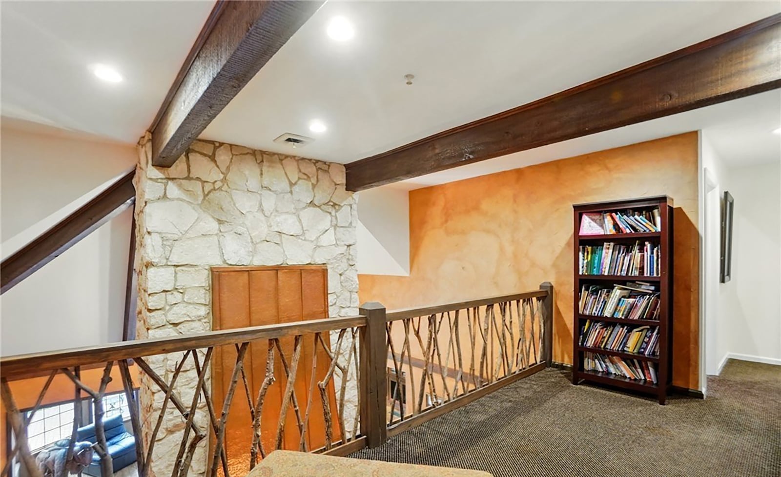 The upstairs has an area that overlooks the dining and family rooms below.