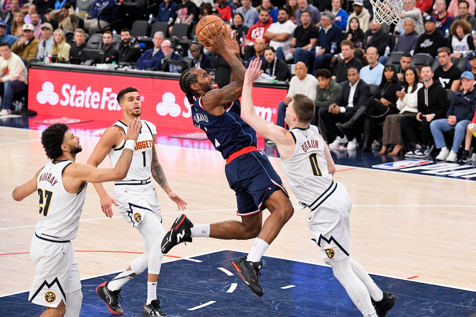 Los Angeles Clippers forward Kawhi Leonard, second from right, shoots as Denver Nuggets guard Jamal Murray, left, forward Michael Porter Jr., second from left, and guard Christian Braun defend during the second half in Game 6 of an NBA basketball first-round playoff series Thursday, May 1, 2025, in Inglewood, Calif. (AP Photo/Mark J. Terrill)