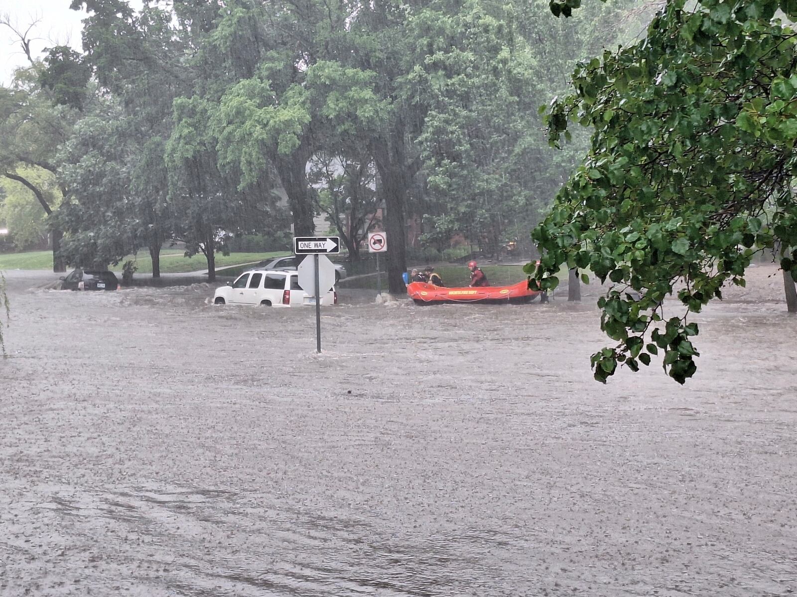 This photo provided by Colin Fee, a vehicle is surrounded by flood waters as heavy rains caused flash flooding in the Wichita area of south-central Kansas forcing firefighters to rescue dozens of people, including stranded motorists on Tuesday, June 3, 2025. (Colin Fee via AP)