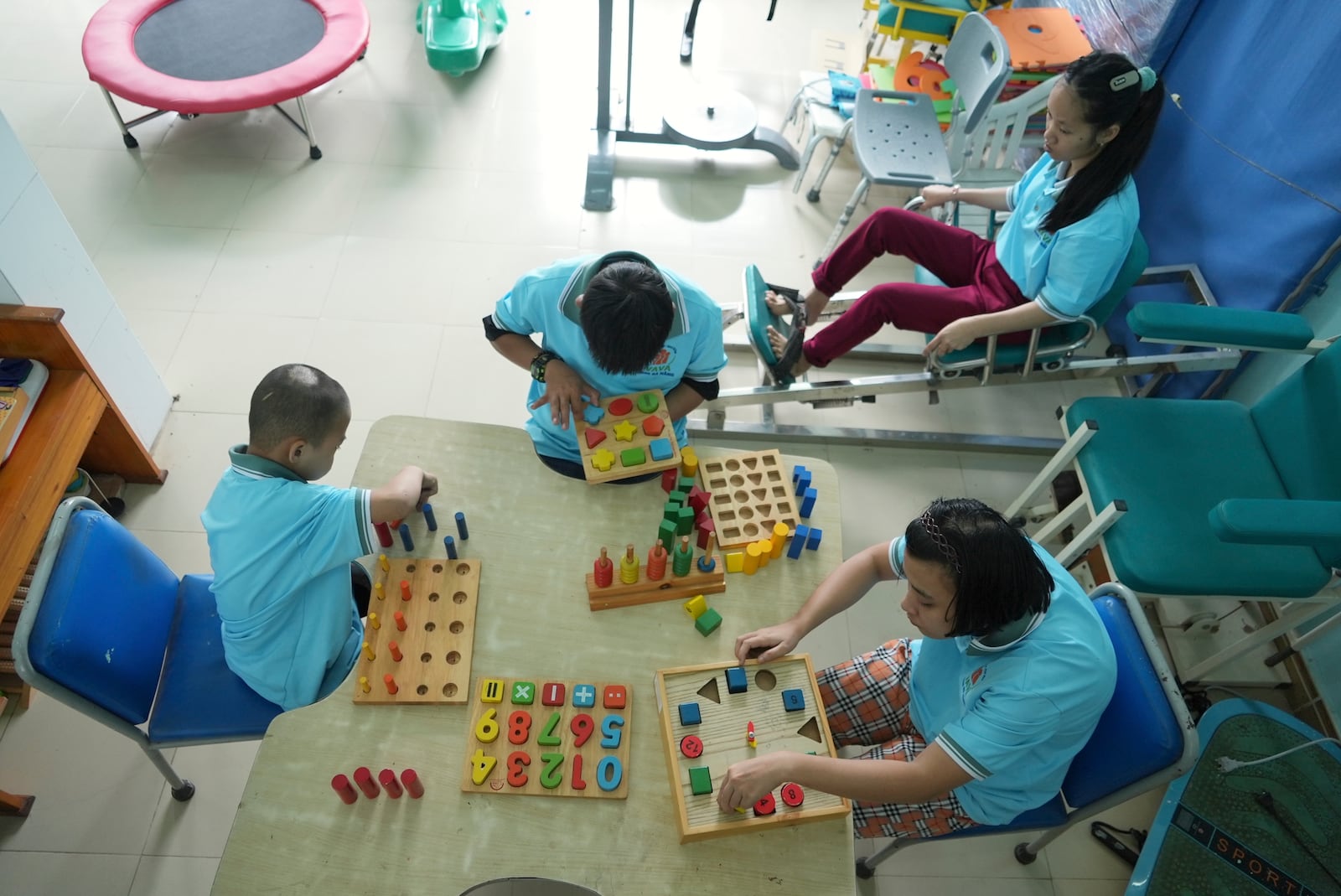 Students exercise and play with wooden blocks in physiotherapy class at a school for victims of Agent Orange in Da Nang, Vietnam, March 7, 2025. (AP Photo/Hau Dinh)