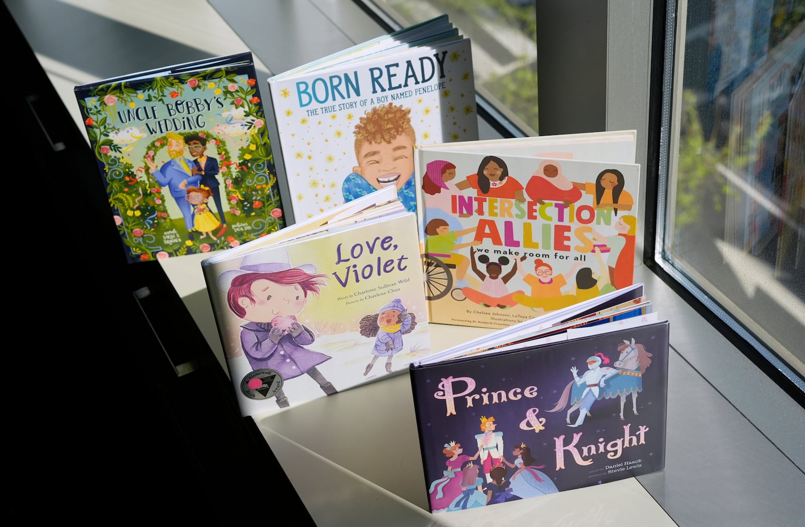 FILE - A selection of books featuring LGBTQ characters that are part of a Supreme Court case are pictured, April, 15, 2025, in Washington. (AP Photo/Pablo Martinez Monsivais, File)