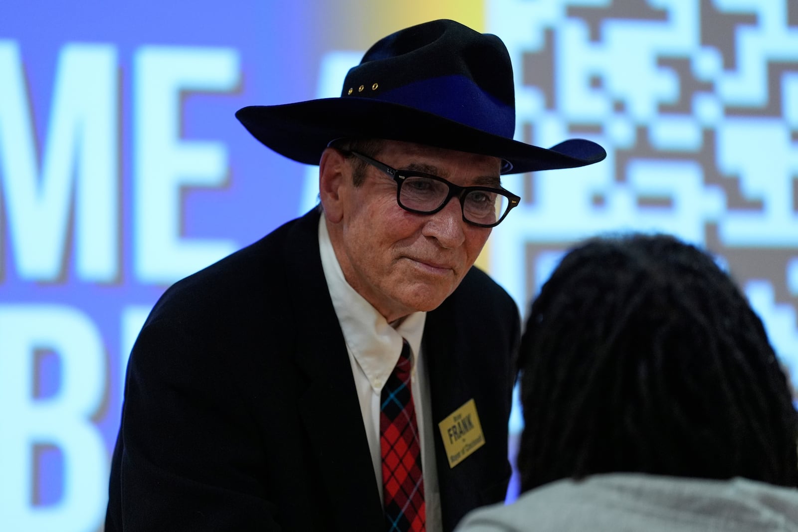 Cincinnati mayoral candidate Brian Frank talks with a person in the audience after participating in a candidate forum with Cincinnati Mayor Aftab Pureval, hosted by the Cincinnati NAACP, Tuesday, April 15, 2025, in Cincinnati.(AP Photo/Carolyn Kaster)