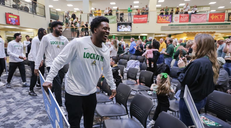 Wright State graduate senior guard Sam Alamutu walks to team seating in the university's Student Union during a Selection Show watch party on Sunday, March 15 in Fairborn. BRYANT BILLING / STAFF