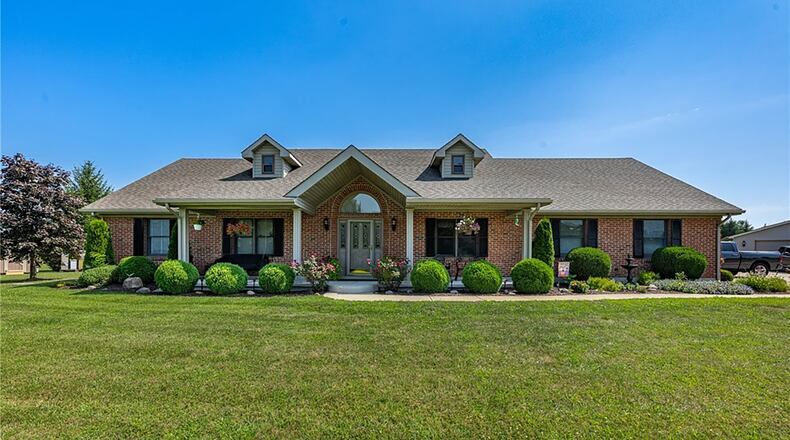 This brick story and a half sits on 2.55 acres in New Carlisle. It has four bedrooms and three bathrooms and has a two car attached and two car detached garage and three additional yard buildings. CONTRIBUTED