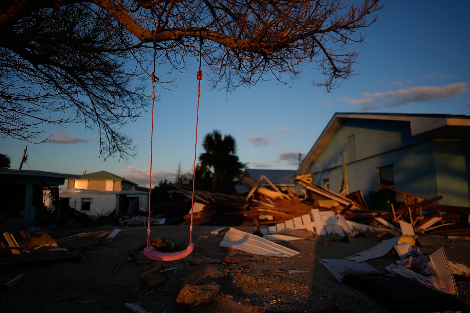 FILE - A child's swing still hangs on a tree, surrounded by debris from homes destroyed by Hurricane Milton, on Manasota Key, Fla., Oct. 12, 2024. (AP Photo/Rebecca Blackwell, File)