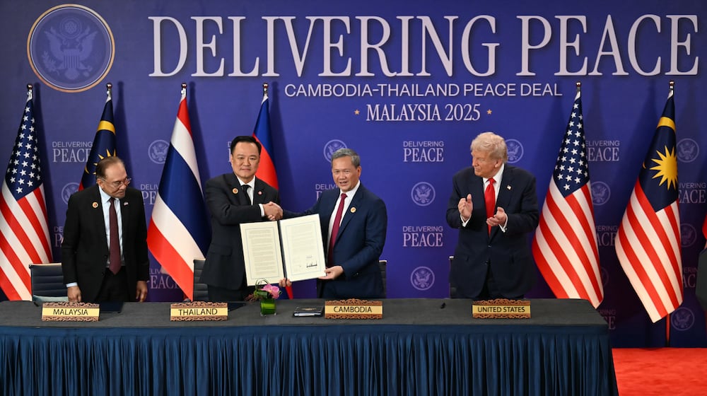 FILE - Malaysia's Prime Minister Anwar Ibrahim, left, and U.S. President Donald Trump, right, watch as Thailand's Prime Minister Anutin Charnvirakul, second left, and Cambodia's Prime Minister Hun Manet hold up a document after the ceremonial signing of a ceasefire agreement between Thailand and Cambodia on the sidelines of the 47th Association of Southeast Asian Nations (ASEAN) summit in Kuala Lumpur, Malaysia, on Oct. 26, 2025. (Mohd Rasfan/Pool Photo via AP, File)
