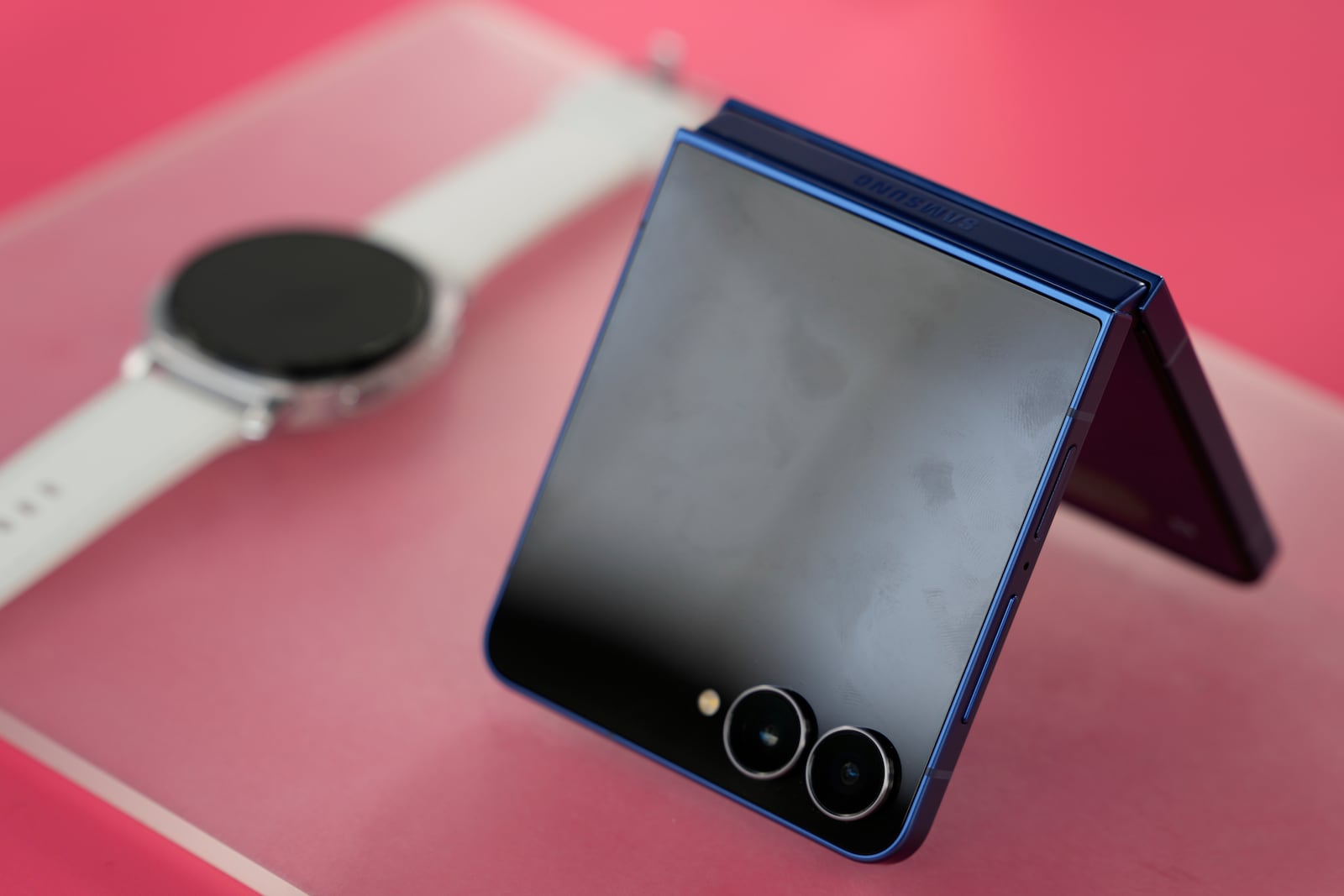 The new Galaxy Z Flip 7 and a smart watch are displayed during a Samsung preview event in New York, Monday, July 7, 2025. (AP Photo/Seth Wenig)