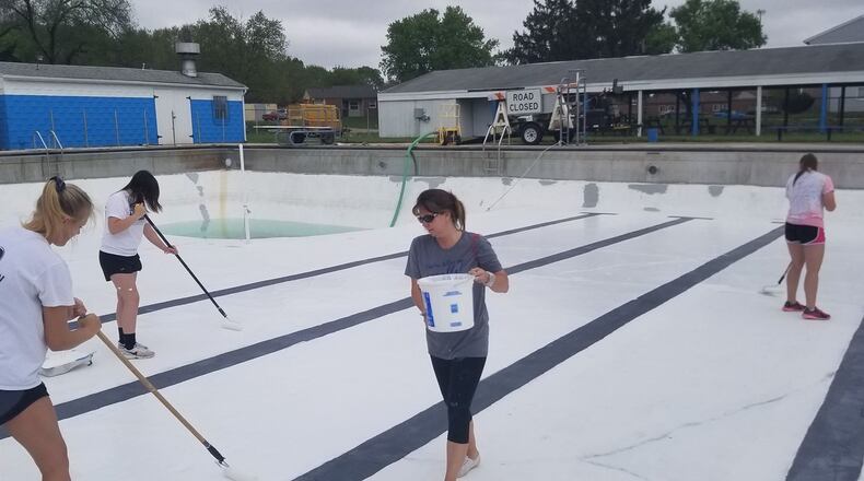 Pool volunteers painted the bottom of the drained swimming pool on Sunday May 5. Submitted by Pool Manager April Lowry.