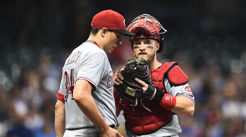 MILWAUKEE, WI - AUGUST 20:  Tucker Barnhart #16 of the Cincinnati Reds speaks with Homer Bailey #34 during the sixth inning of a game against the Milwaukee Brewers at Miller Park on August 20, 2018 in Milwaukee, Wisconsin.  (Photo by Stacy Revere/Getty Images)