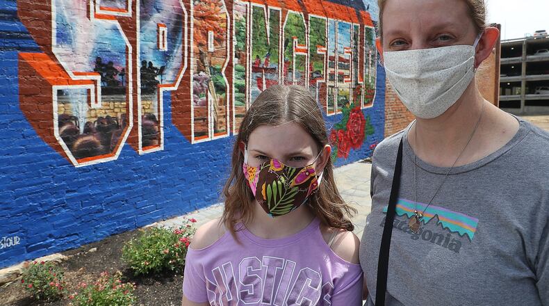 Kristen Collier and her daughter, Kara, 10 were wearing their masks as the went in Winans recently. BILL LACKEY/STAFF
