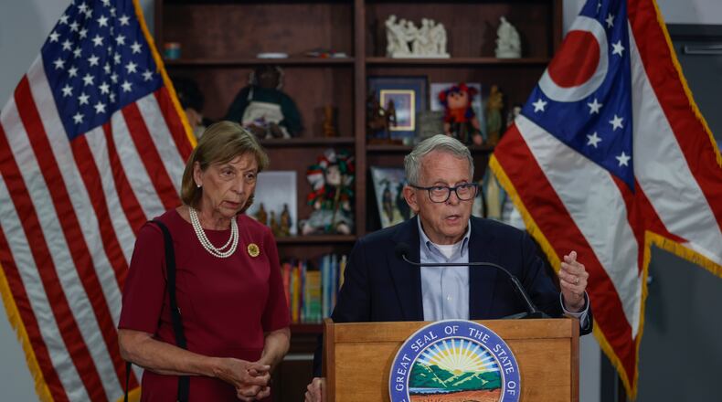 First Lady Fran DeWine, left, listens as her husband Gov. Mike DeWine speaks at a press conference about the current needs of Springfield on Friday, July 25, 2025, at St. Vincent de Paul. JOSEPH COOKE/STAFF