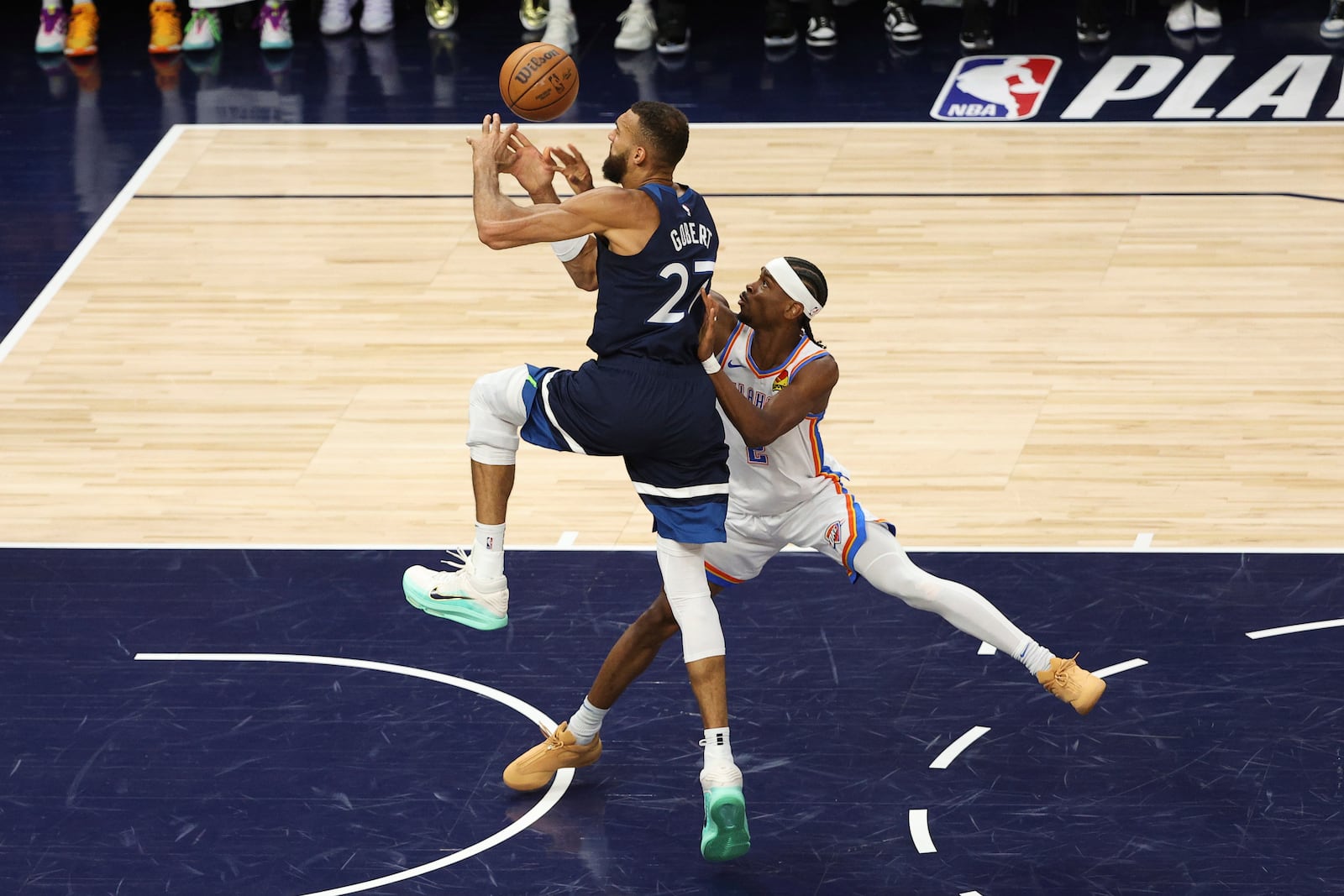 Oklahoma City Thunder guard Shai Gilgeous-Alexander (2) defends against Minnesota Timberwolves center Rudy Gobert (27) during the first half of Game 3 of the Western Conference finals of the NBA basketball playoffs, Saturday, May 24, 2025, in Minneapolis. (AP Photo/Matt Krohn)