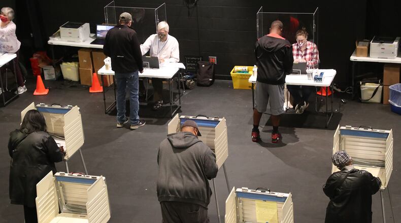 Clark County residents cast their votes at Clark State's Turner Studio Theater during the first day of early voting that started last week. BILL LACKEY/STAFF